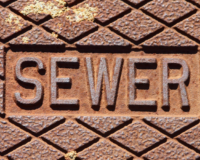 a sewer manhole cover representing the issues around wastewater in suburban Adelaide.